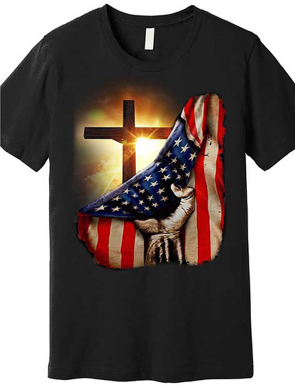 Men's Graphic T-Shirt Dramatic Sunlit Cross With Waving American Flag Draped Over Powerful Hand