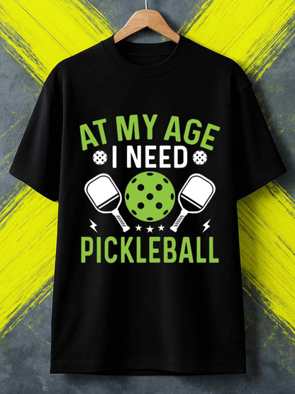 Men's Graphic T-Shirt At My Age I Need Pickleball Green Ball And Two Rackets Surrounded By Lightning