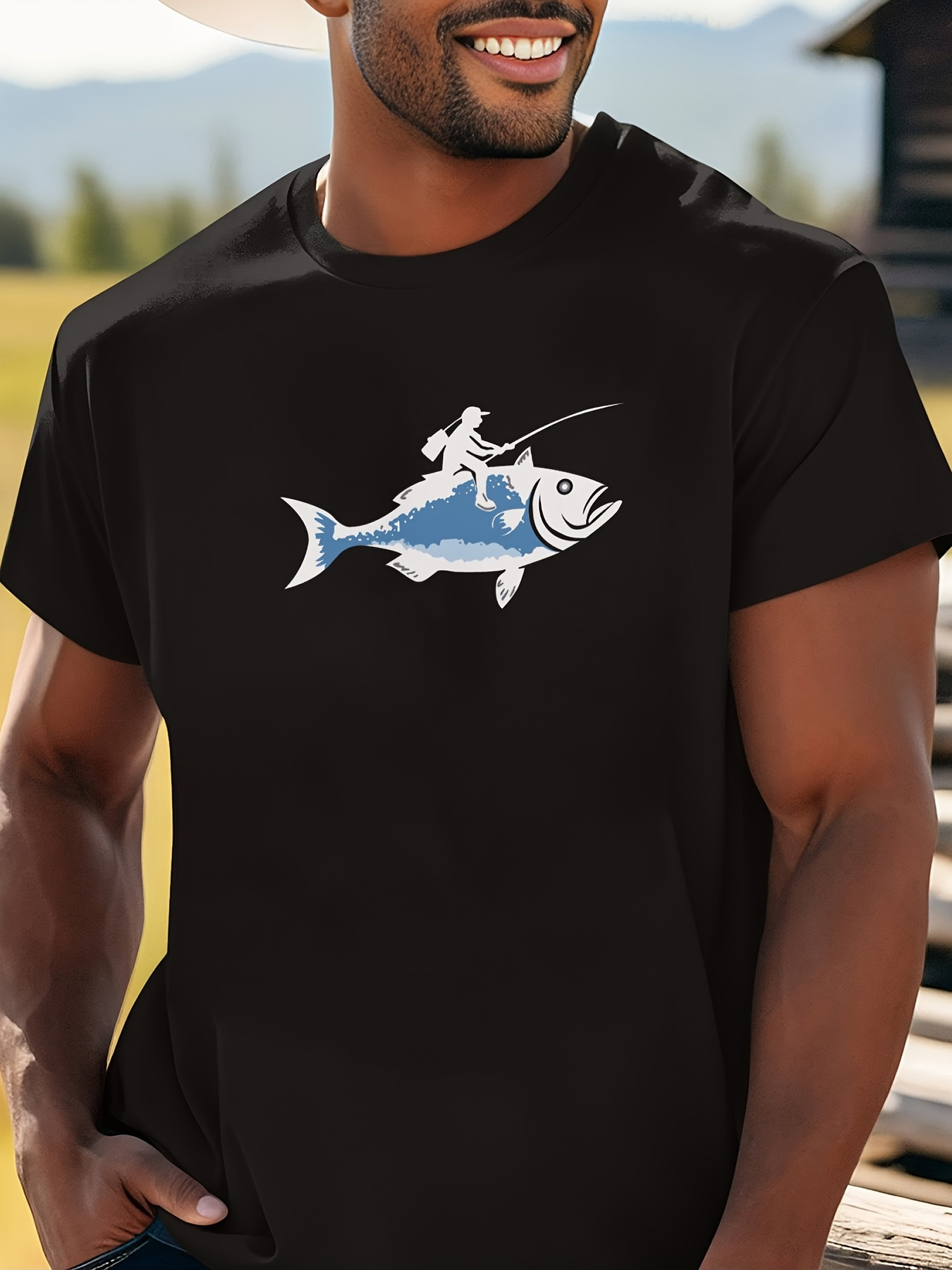 Men's Graphic T-Shirt Playful Adventure With Fisherman Riding On Smiling Blue Fish