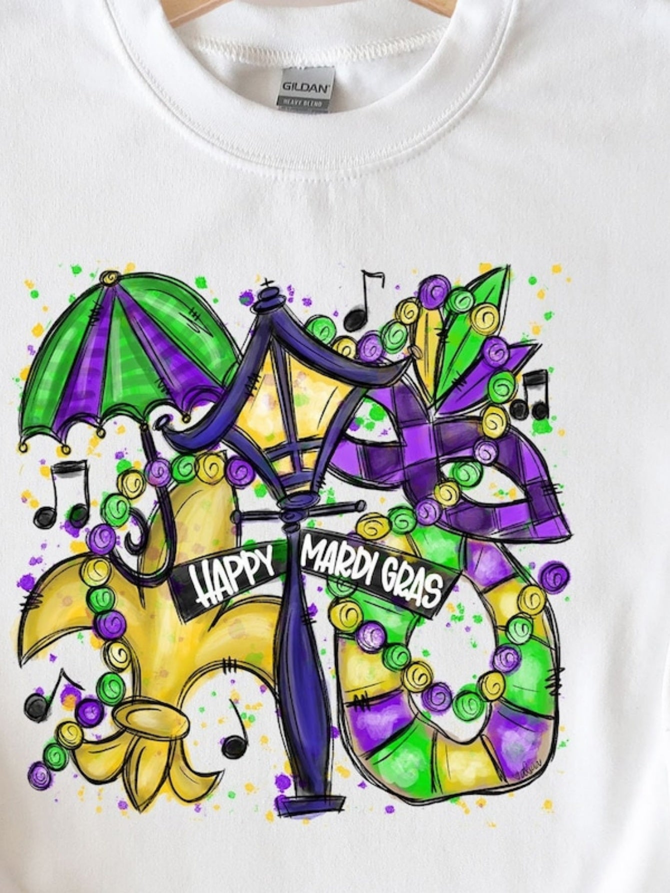 Men's Graphic T-Shirt Happy Mardi Gras Mask With Beads Among Music Notes And Festive Lamp