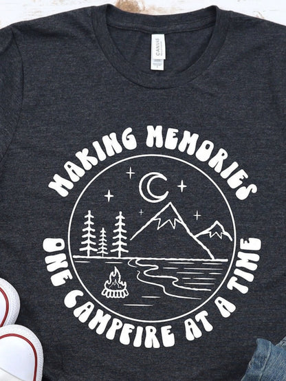 Men's Graphic T-Shirt Making Memories Under Crescent Moon Beside River With Pine Trees And Campfire Mountain