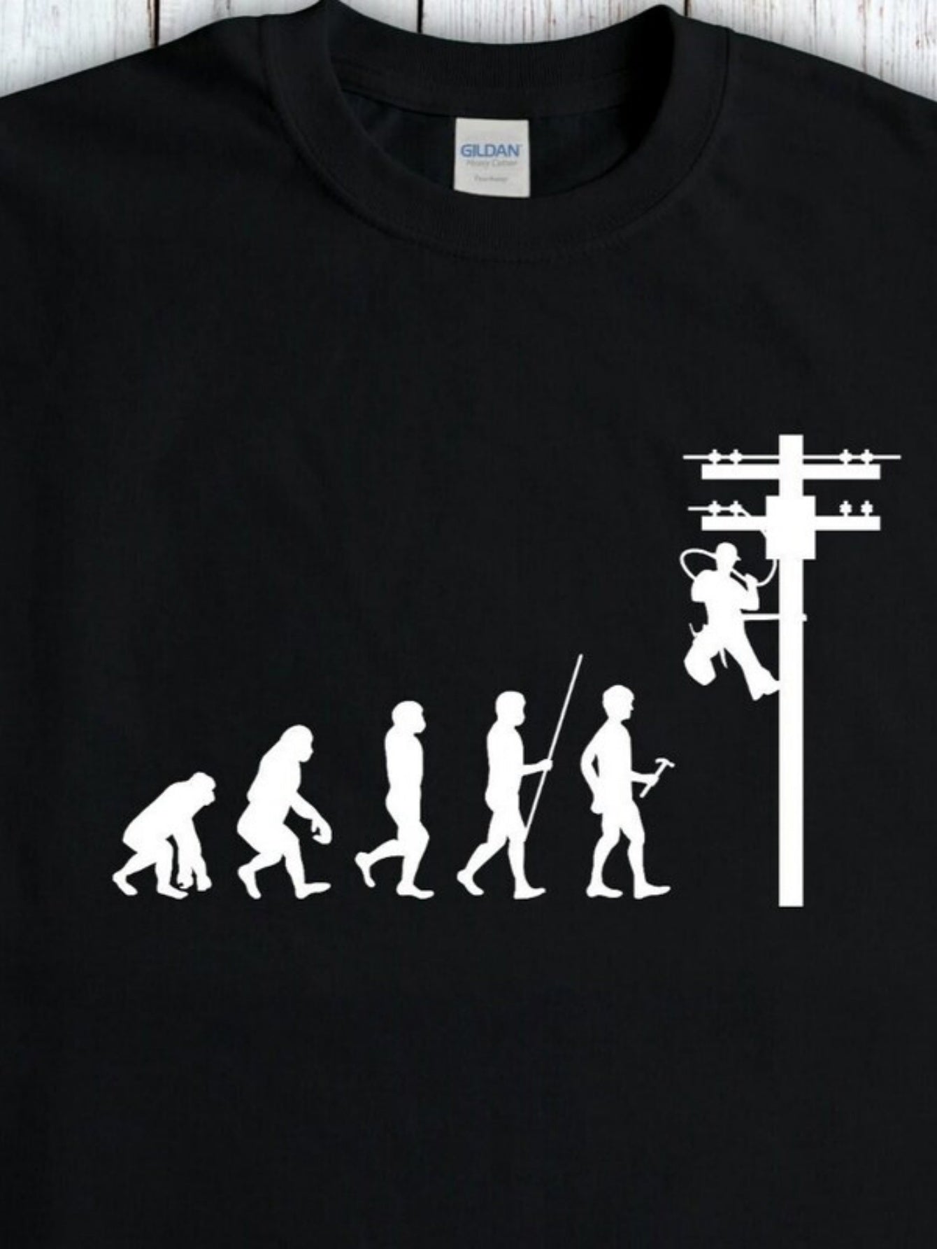 Men's Graphic T-Shirt Evolution Of Human Climbing Utility Pole Under Black Sky