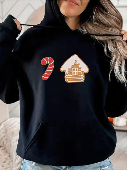 Women's Graphic Hoodie Cozy Festive Winter With Candy Cane Beside Gingerbread House