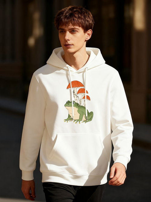 Men's Graphic Hoodie Whimsical Frog Resting Under Orange Mushrooms In Lush Green Grass